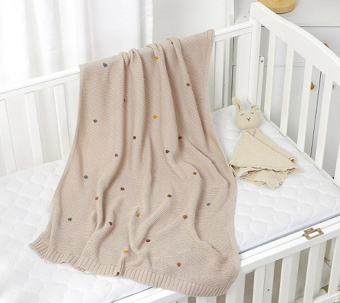 Bowie Knitted Baby Blanket. Size 90x70 cm on cot