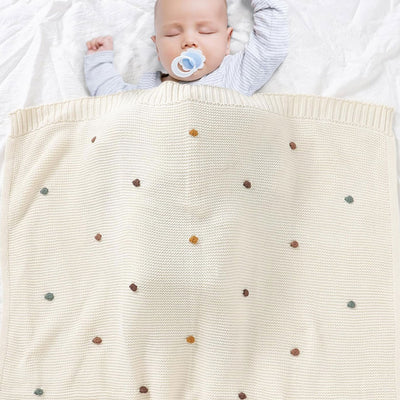 Kyrie Knitted Baby Blanket. Size 90x70 cm with baby